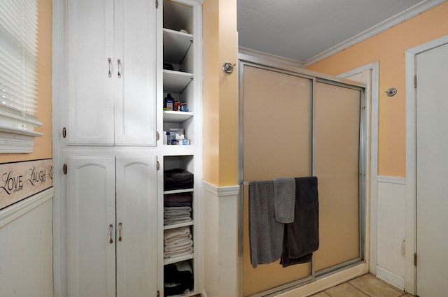 bathroom featuring ornamental molding and tile patterned flooring