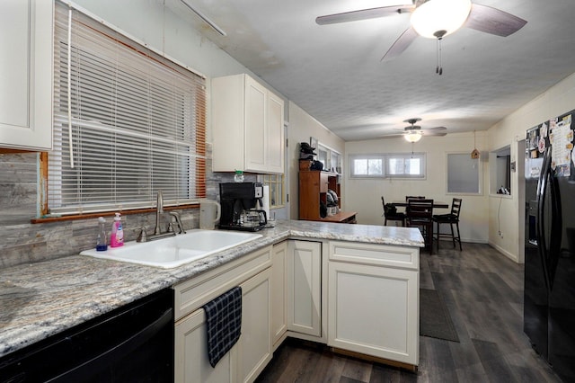 kitchen with white cabinets, black appliances, dark wood-type flooring, sink, and kitchen peninsula