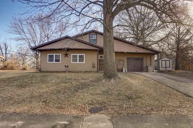 view of front of house with a garage and a storage shed