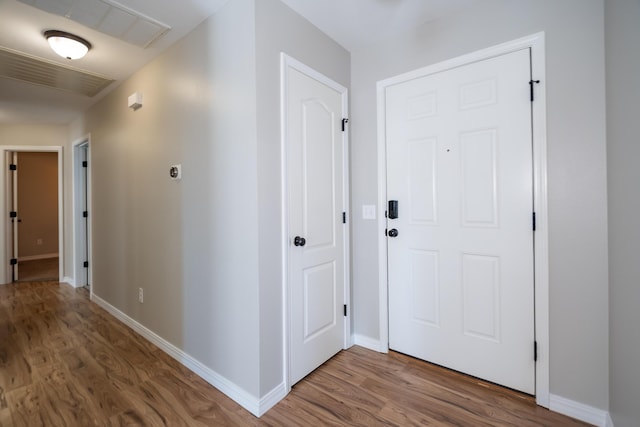 corridor with wood-type flooring