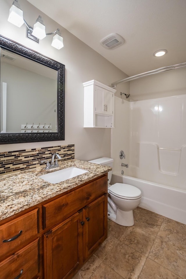 full bathroom with tasteful backsplash, vanity, shower / washtub combination, and toilet