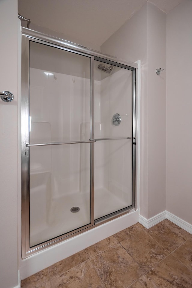 bathroom with a shower with shower door