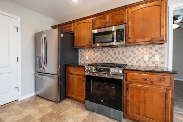 kitchen with backsplash and appliances with stainless steel finishes