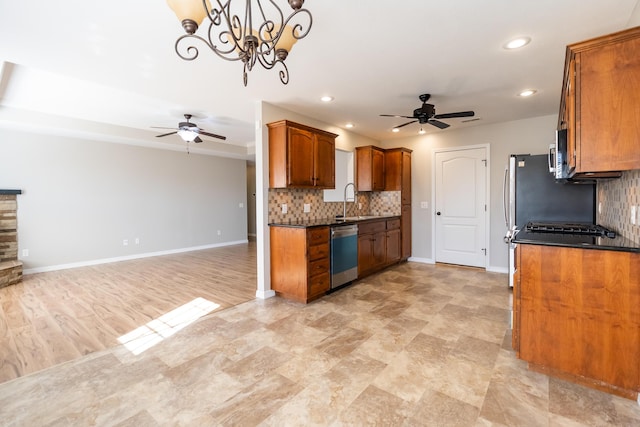 kitchen featuring tasteful backsplash, appliances with stainless steel finishes, and ceiling fan