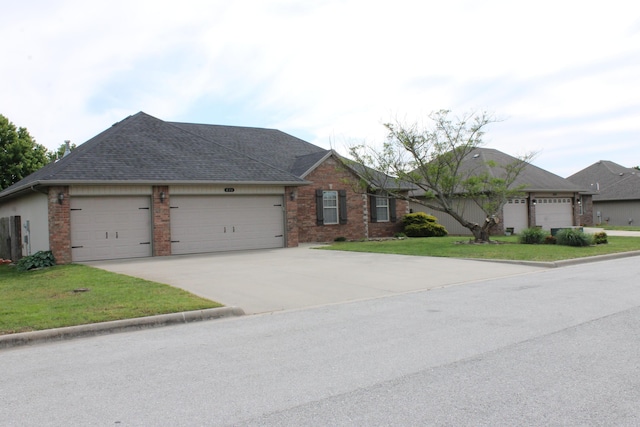 816 E Roubidoux St, Nixa, MO 65714 - view of front of property with an attached garage, driveway, brick siding, and a front yard