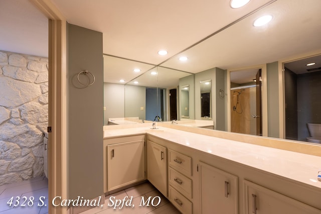 bathroom with vanity, walk in shower, and tile patterned floors