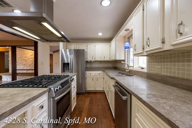 kitchen featuring appliances with stainless steel finishes, island exhaust hood, sink, backsplash, and dark hardwood / wood-style floors