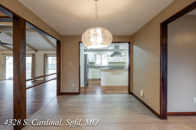 unfurnished dining area featuring plenty of natural light