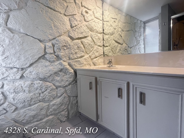 bathroom with tile patterned flooring and vanity