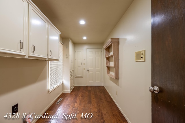 corridor featuring dark wood-type flooring