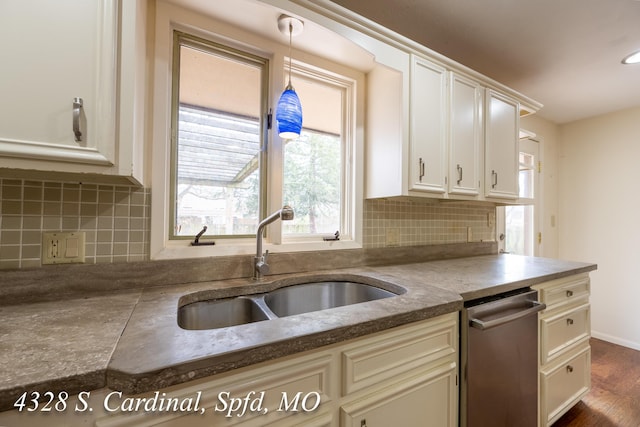 kitchen featuring sink, pendant lighting, dark hardwood / wood-style flooring, and tasteful backsplash