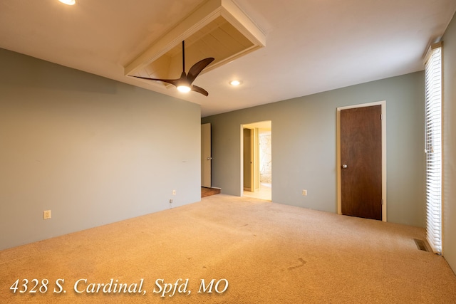 unfurnished bedroom featuring ceiling fan, ensuite bathroom, and carpet flooring