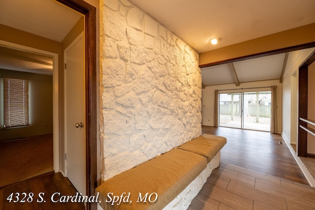 hallway with lofted ceiling with beams