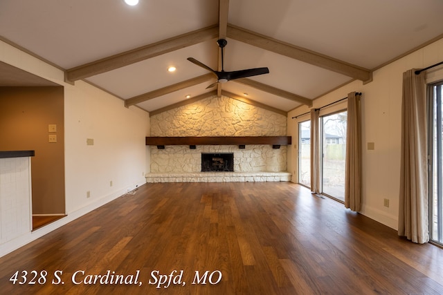 unfurnished living room with ceiling fan, dark hardwood / wood-style flooring, lofted ceiling with beams, and a fireplace