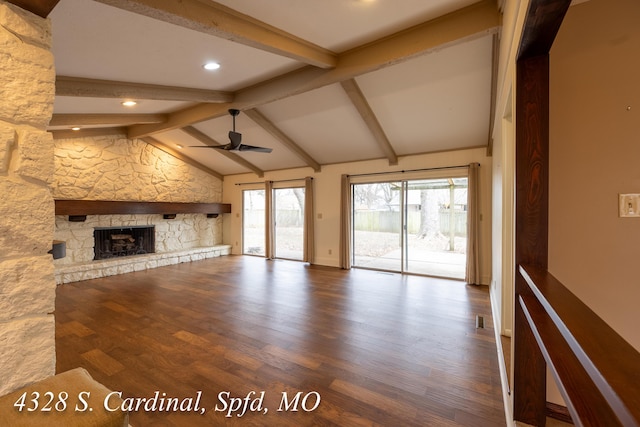 unfurnished living room featuring a fireplace, hardwood / wood-style flooring, vaulted ceiling with beams, and ceiling fan