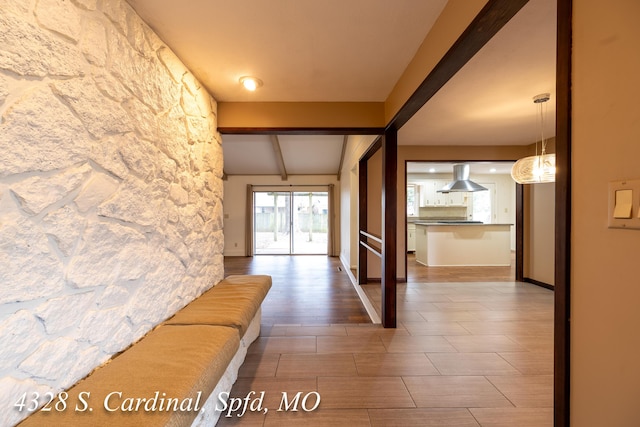 hall featuring lofted ceiling