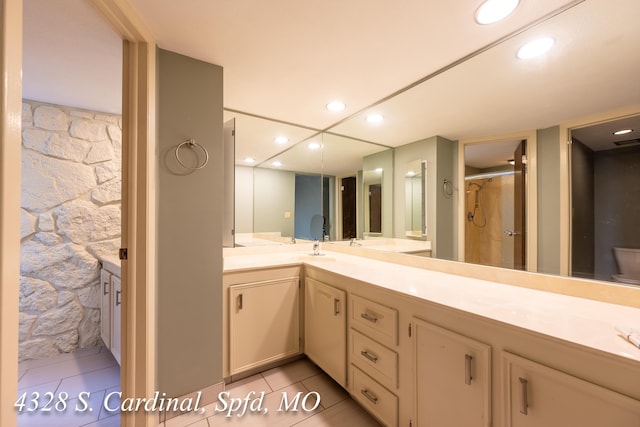 bathroom featuring vanity, walk in shower, and tile patterned flooring