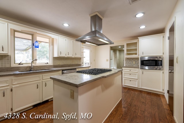 kitchen featuring sink, white cabinets, a kitchen island, island range hood, and stainless steel appliances