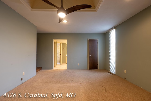 carpeted spare room with ceiling fan and ornamental molding