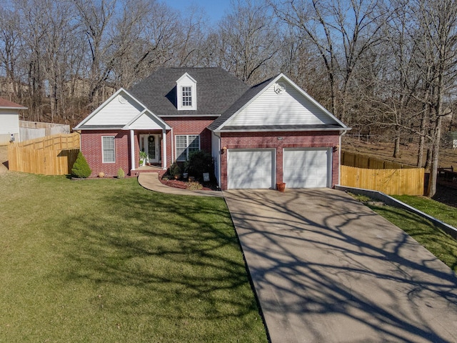 view of front of home with brick siding, an attached garage, a front lawn, fence, and driveway