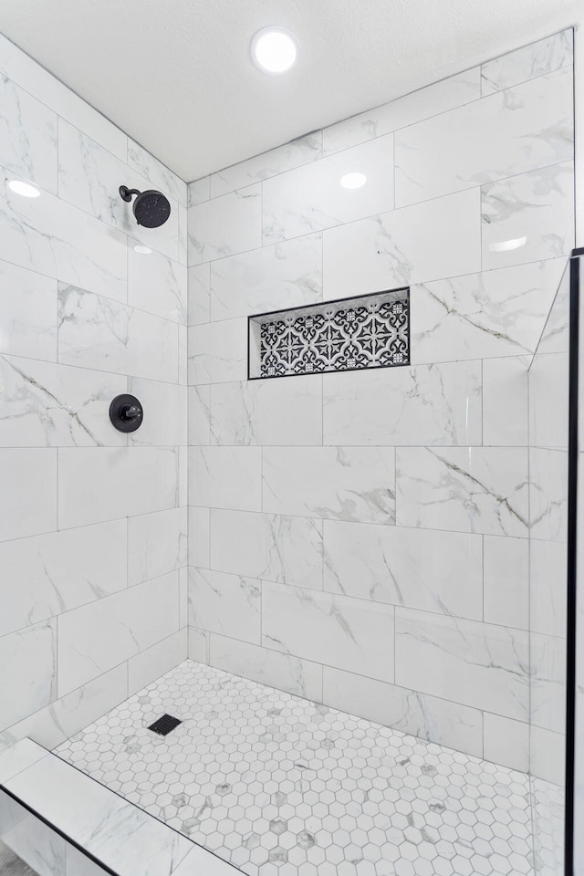 bathroom with tiled shower