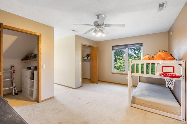 carpeted bedroom with a closet and ceiling fan