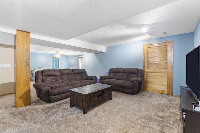 carpeted living room with a textured ceiling