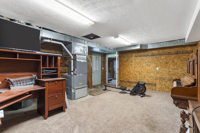 basement with a textured ceiling, heating unit, and carpet flooring