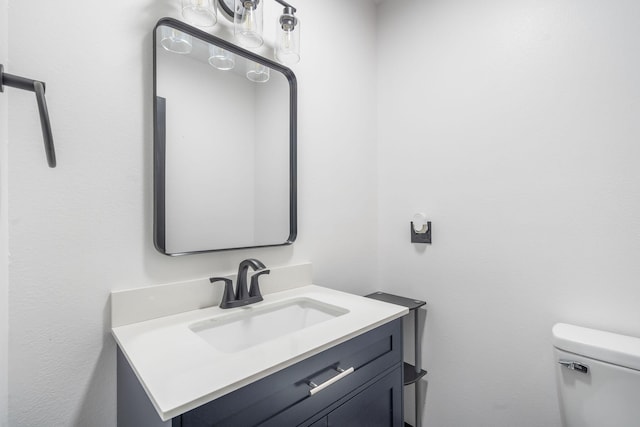 bathroom featuring toilet and vanity