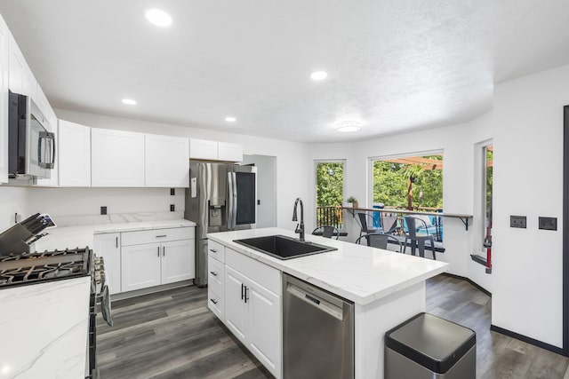 kitchen featuring sink, an island with sink, white cabinetry, and appliances with stainless steel finishes