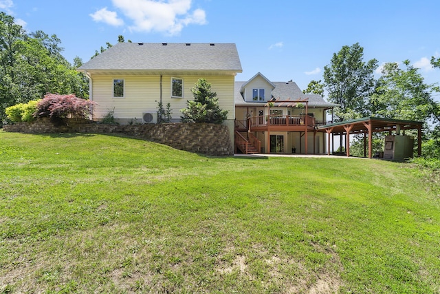 rear view of property with ac unit, a lawn, and a deck