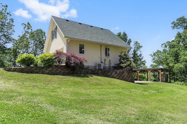 rear view of property with ac unit and a lawn