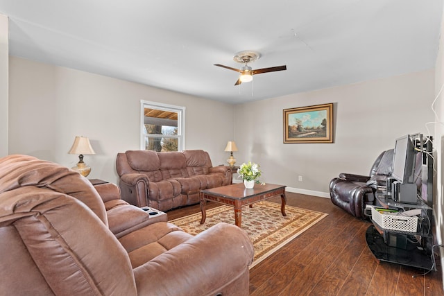 living room with ceiling fan and dark wood-type flooring