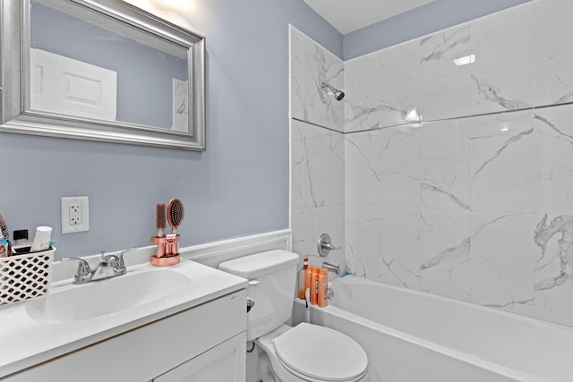 full bathroom featuring tiled shower / bath combo, vanity, and toilet