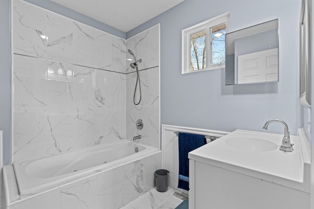 bathroom featuring vanity and tiled shower / bath combo