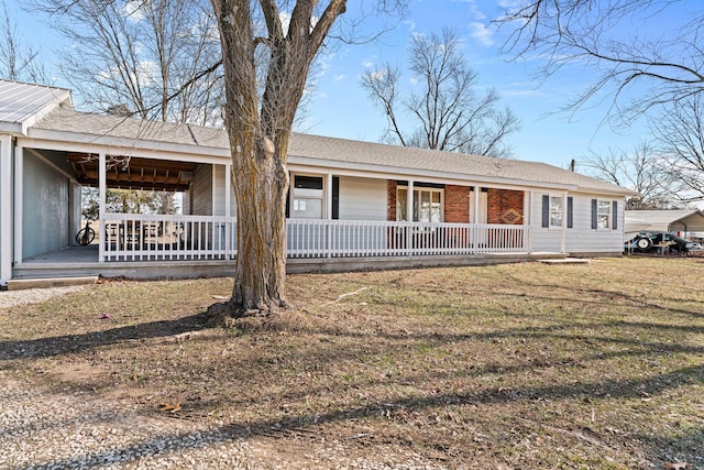 ranch-style home with covered porch and a front lawn