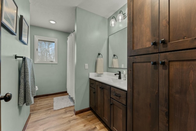 bathroom with wood-type flooring and vanity