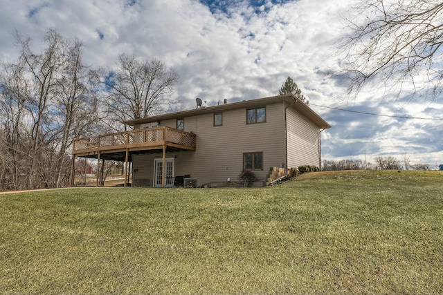 back of property featuring a wooden deck and a yard