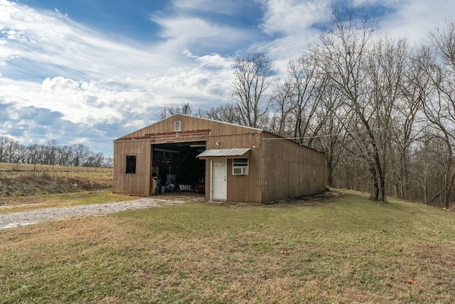 view of outdoor structure featuring a lawn