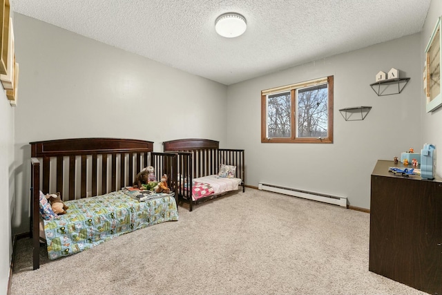 bedroom featuring a baseboard heating unit, carpet floors, and a textured ceiling