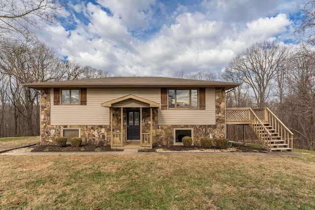 split foyer home with a front lawn