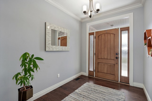 entryway with a chandelier, ornamental molding, and dark hardwood / wood-style flooring