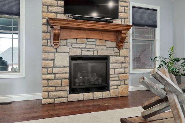 details with hardwood / wood-style flooring and a fireplace