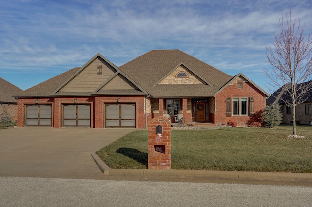 craftsman house with a garage and a front lawn