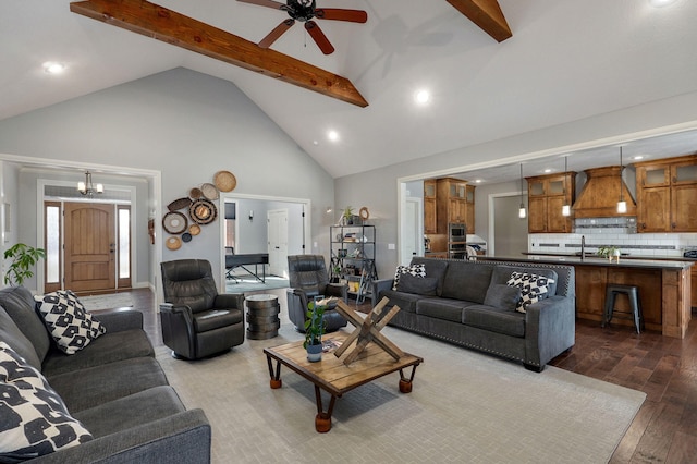 living room with high vaulted ceiling, dark wood-type flooring, beam ceiling, and ceiling fan