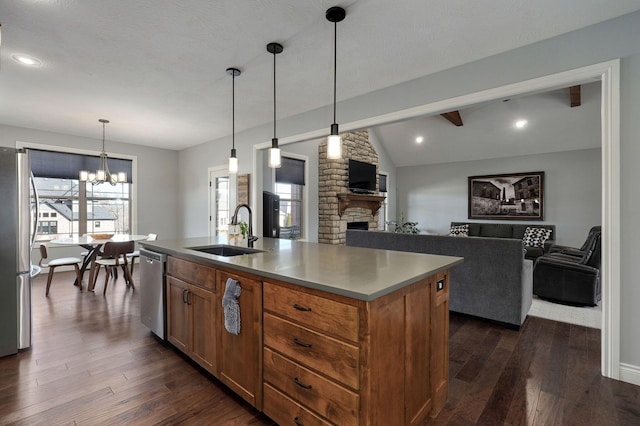 kitchen with sink, vaulted ceiling with beams, stainless steel appliances, a center island with sink, and dark hardwood / wood-style floors