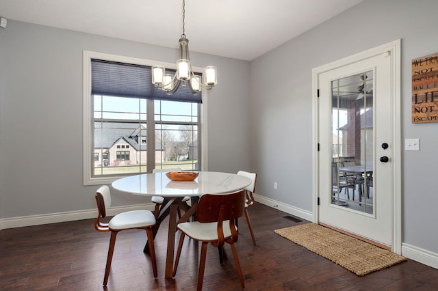 dining area featuring a chandelier and dark hardwood / wood-style floors