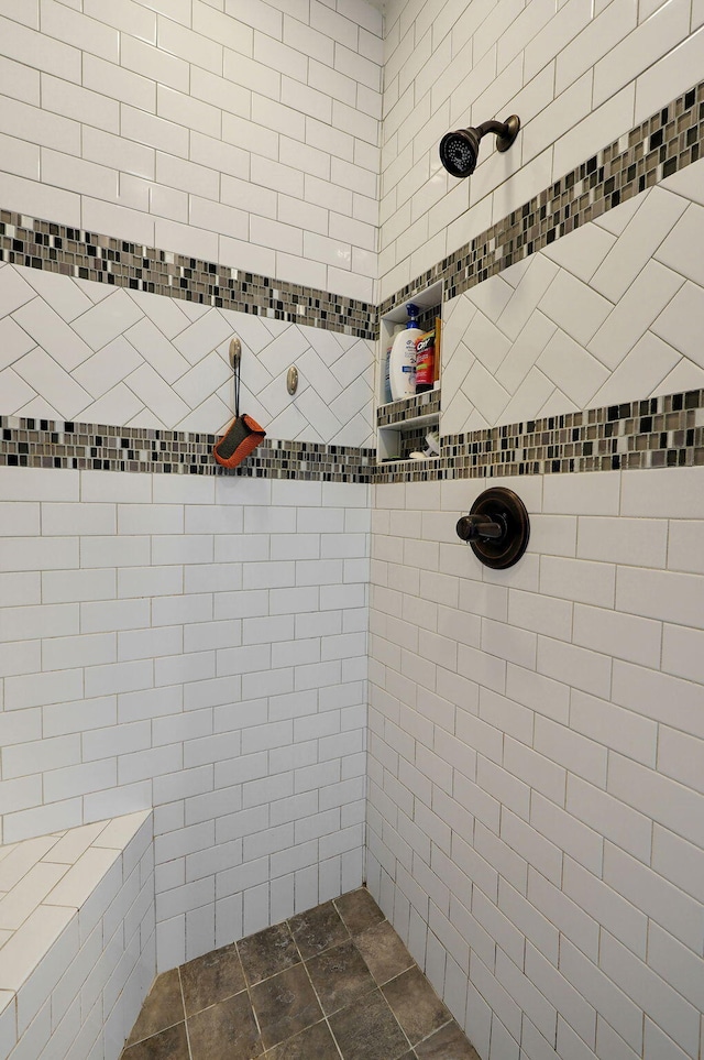 bathroom with a tile shower