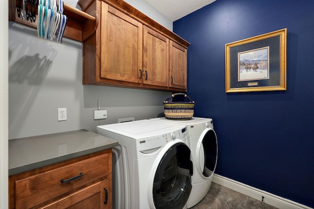 laundry area with washer and dryer and cabinets