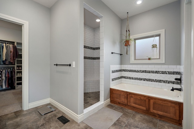 bathroom featuring plus walk in shower